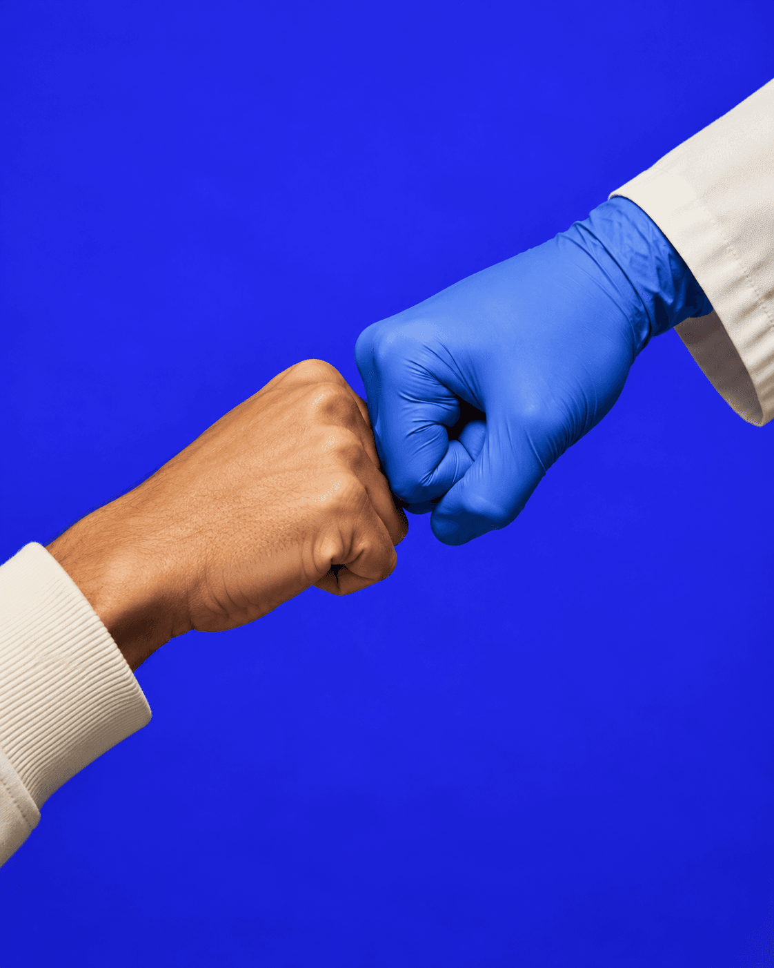 A clinician greeting a friend with a fist bump